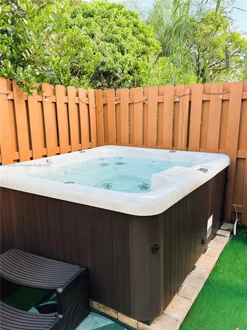 a backyard of a house with yard fountain and outdoor seating