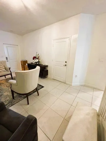 a living room with furniture and a rug