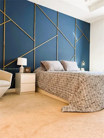 a bedroom with a bed and lamp