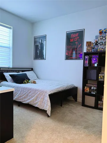 a bed room with a bed and a desk