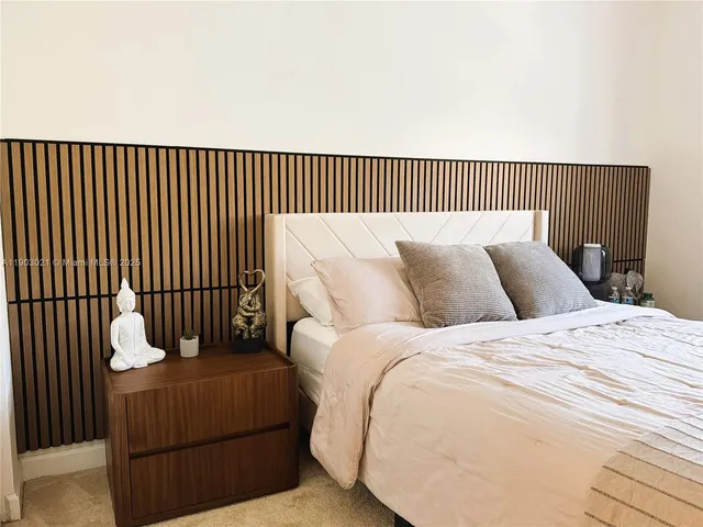 a bedroom with a bed and walk in closet