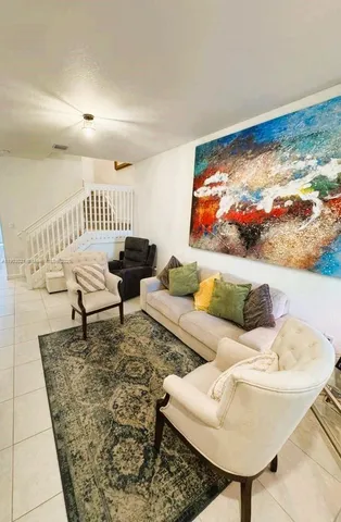 a living room with furniture and a rug