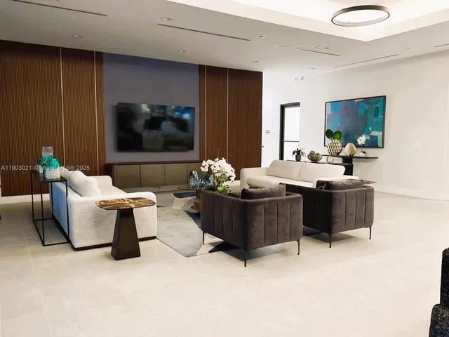 a view of living room filled with furniture and large window