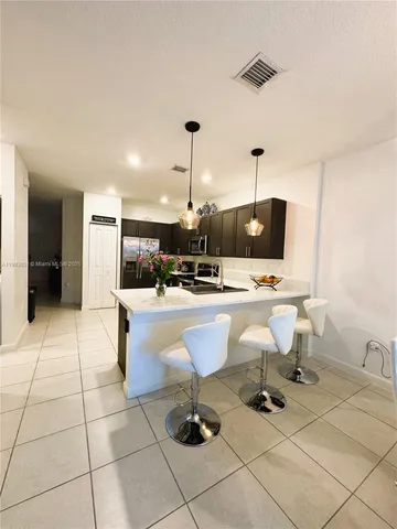 a view of living room with dining area and appliances