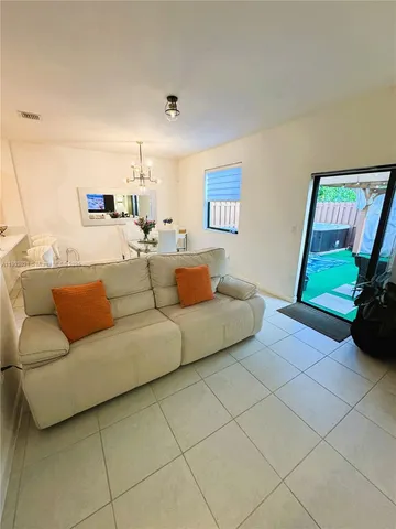 a living room with furniture and a mirror