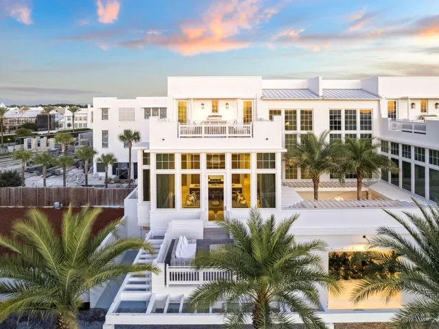 a view of a patio with couches plants and city view