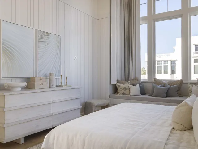 a spacious bedroom with a large bed and a large window