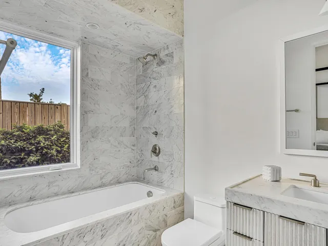 a bedroom with a large bed and a large window