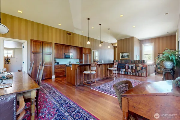 a living room with lots of furniture and kitchen view
