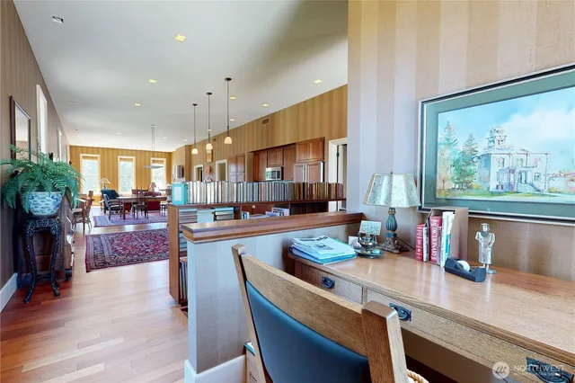 a kitchen with a table chairs stove and wooden floor