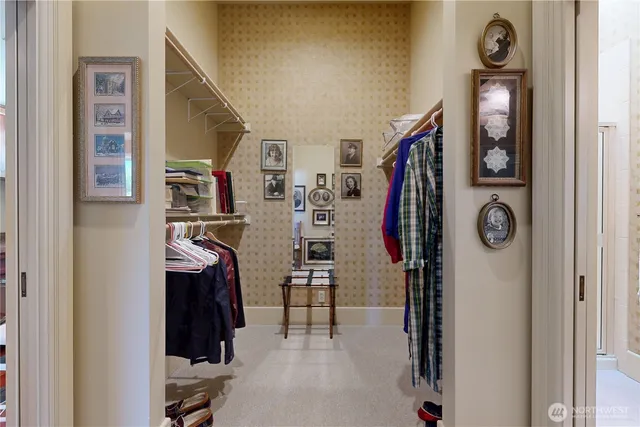 a view of walk in closet with clothes