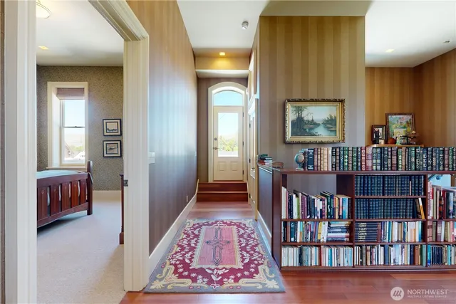 a view of a hallway to rooms and stairs