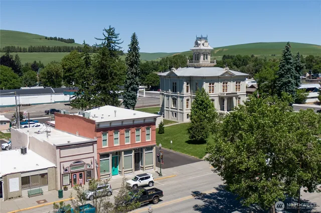 a front view of a building with a garden