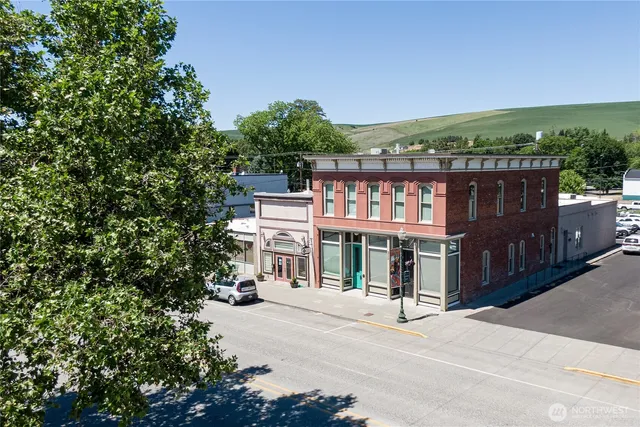 a view of a door and utility room with racks on a wall