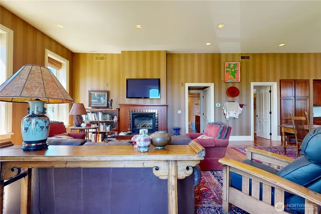 a living room with furniture a fireplace and a flat screen tv