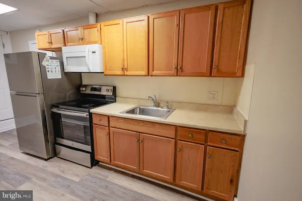 a kitchen with stainless steel appliances a stove a microwave and a refrigerator