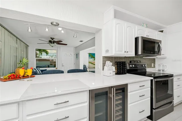 a kitchen with stainless steel appliances granite countertop a sink a stove and cabinets