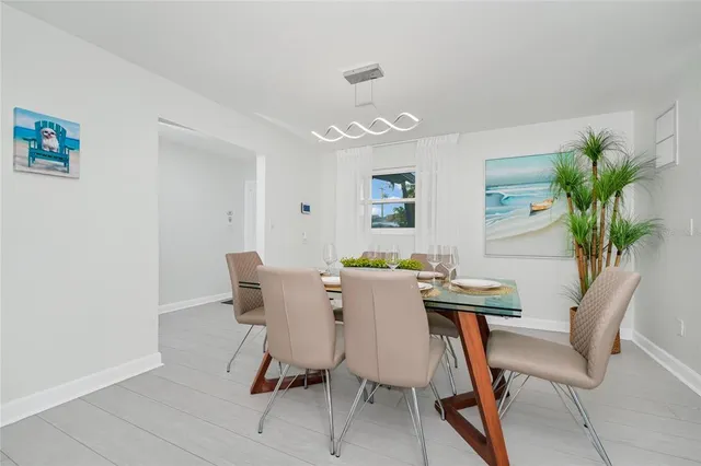 a view of a dining room with furniture and a potted plant