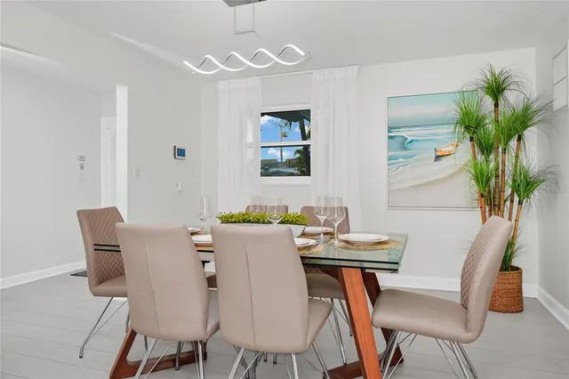 a view of a dining room with furniture and a potted plant