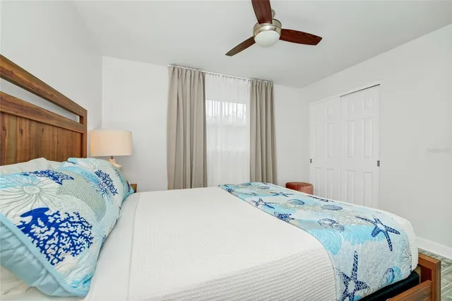 a bedroom with a bed and a painting on the wall