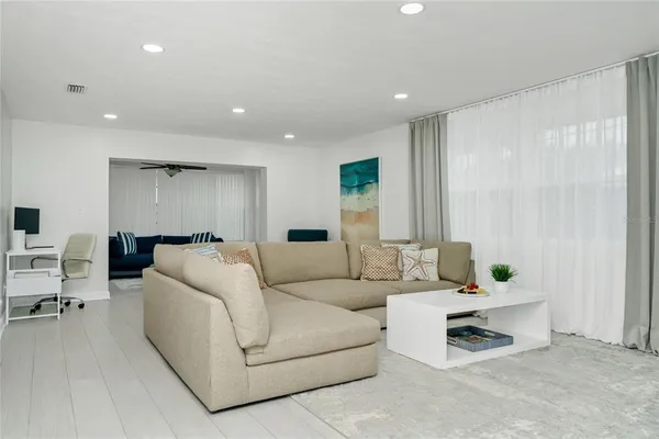 a living room with furniture and a potted plant