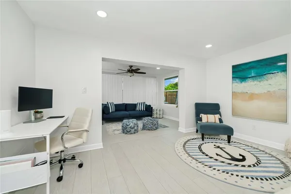 a work room with furniture and a flat screen tv
