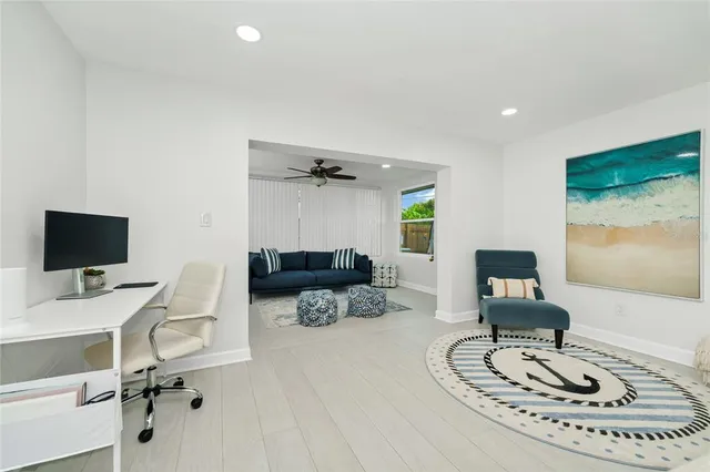 a work room with furniture and a flat screen tv