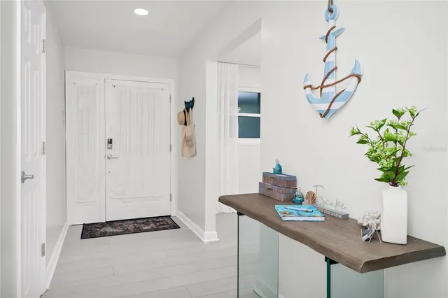 a view of kitchen with sink and refrigerator