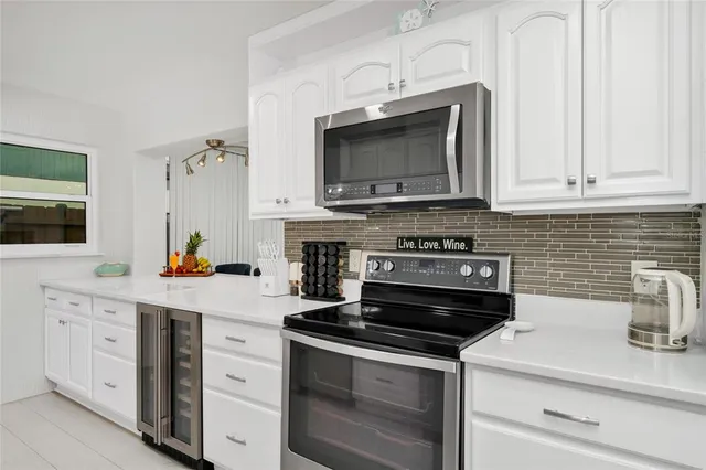a kitchen with stainless steel appliances a stove a microwave a sink and cabinets