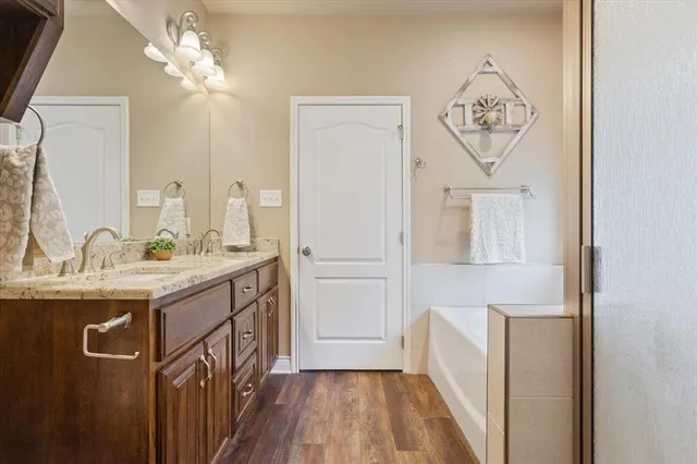 a bathroom with a sink a mirror and a shower