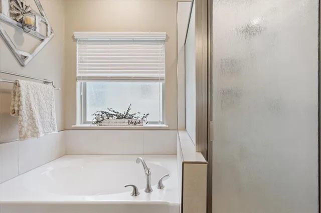 a white bath tub sitting next to a window