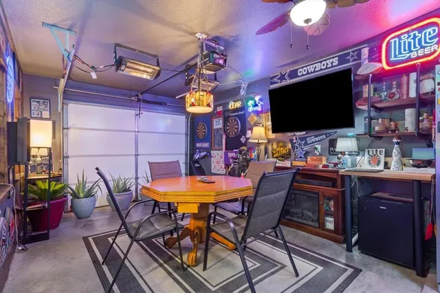 a view of a room with furniture and a flat screen tv