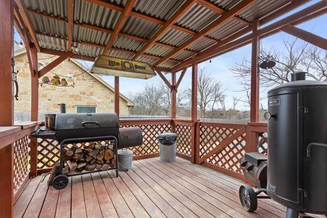 a balcony view with a sitting space and large trees