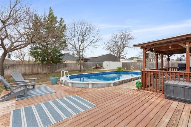 a view of a house with swimming pool and sitting area
