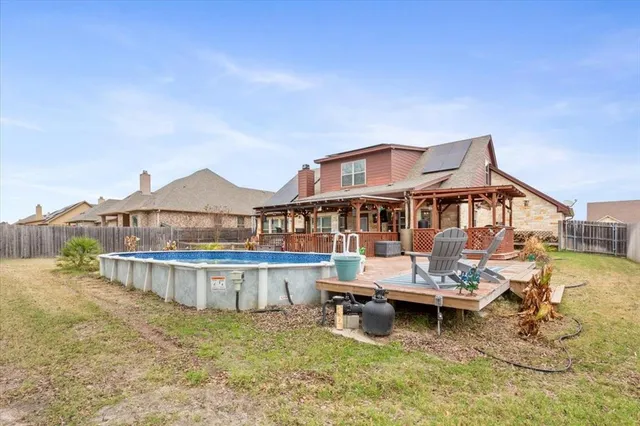 a view of a house with pool and chairs