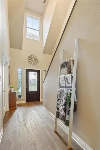 a view of an entryway with wooden floor and windows