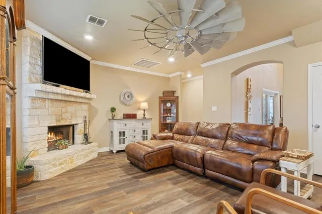 a living room with furniture fireplace and flat screen tv