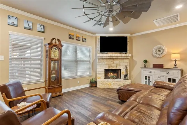 a living room with furniture a flat screen tv and a fireplace