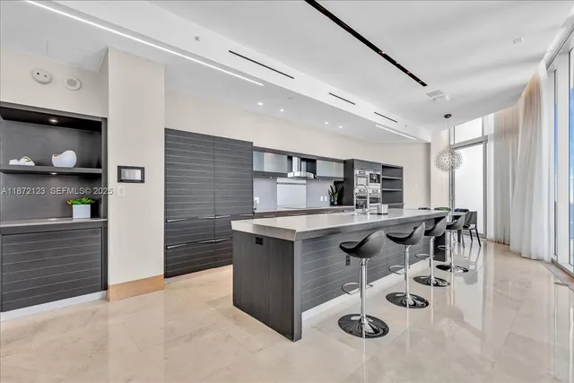 a kitchen with stainless steel appliances kitchen island granite countertop a stove and cabinets