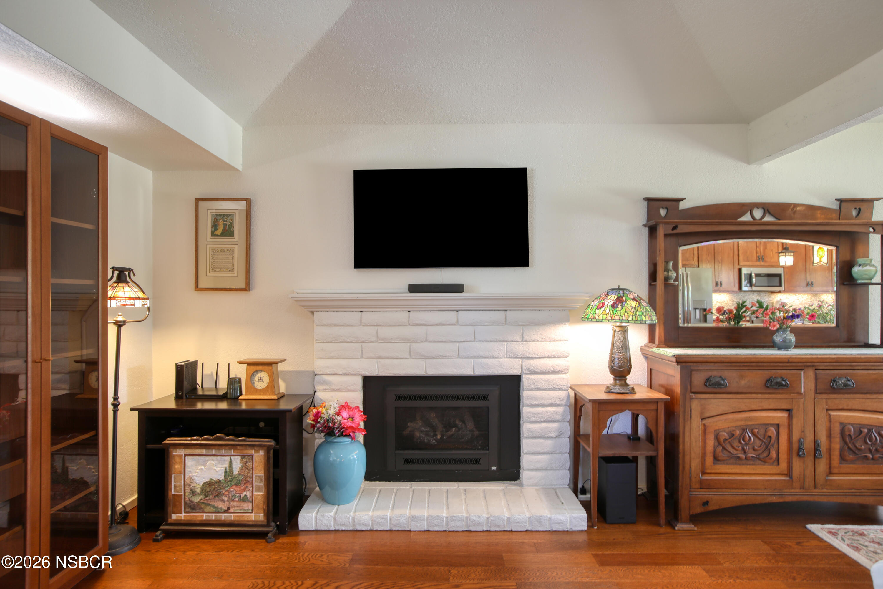 435-433 Eucalyptus Road, Unit 435433 Nipomo, CA 93444 - Photo 13 of 78 a living room with furniture a fireplace and a flat screen tv