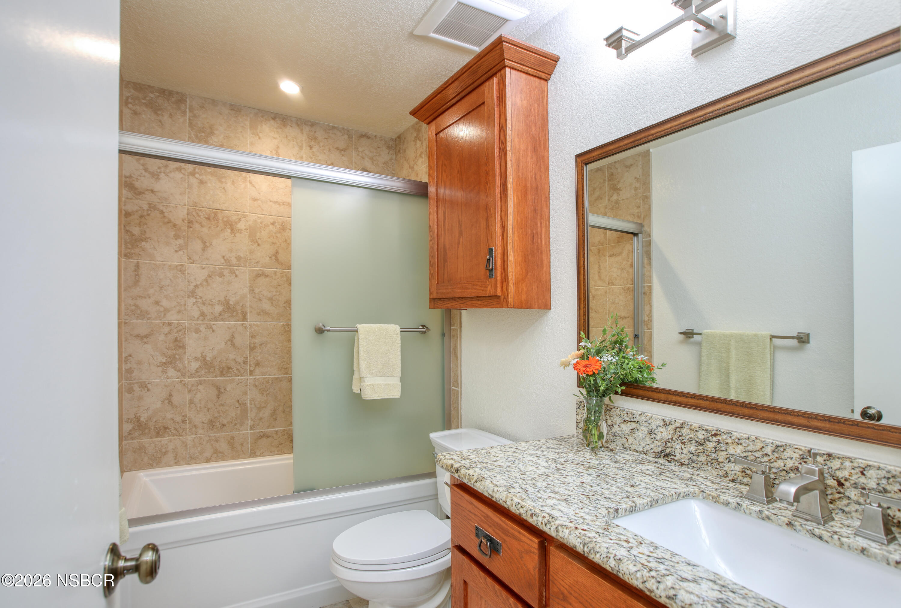 435-433 Eucalyptus Road, Unit 435433 Nipomo, CA 93444 - Photo 14 of 78 a bathroom with a granite countertop sink a mirror and a bathtub