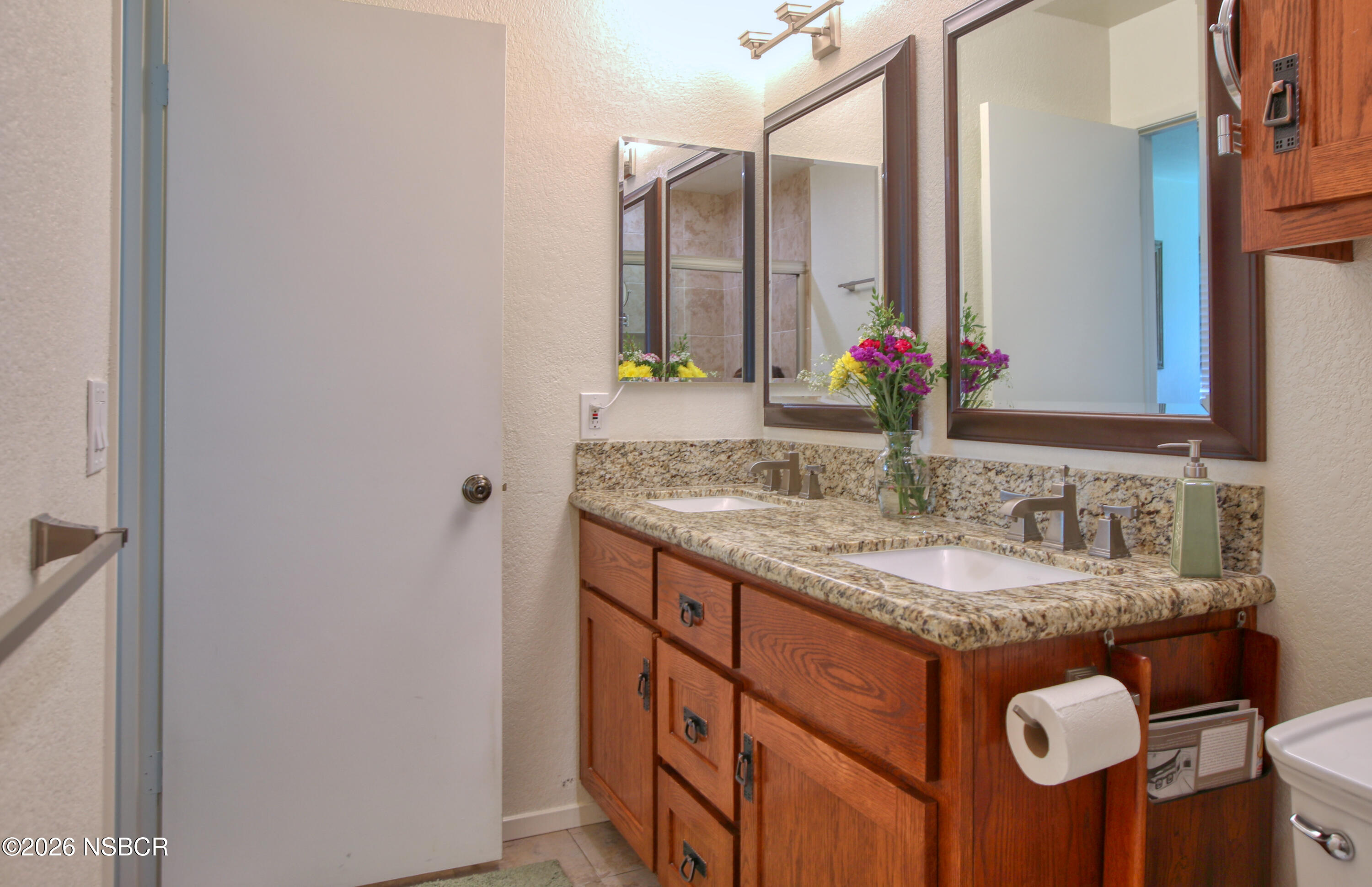 435-433 Eucalyptus Road, Unit 435433 Nipomo, CA 93444 - Photo 19 of 78 a bathroom with a granite countertop sink and a mirror