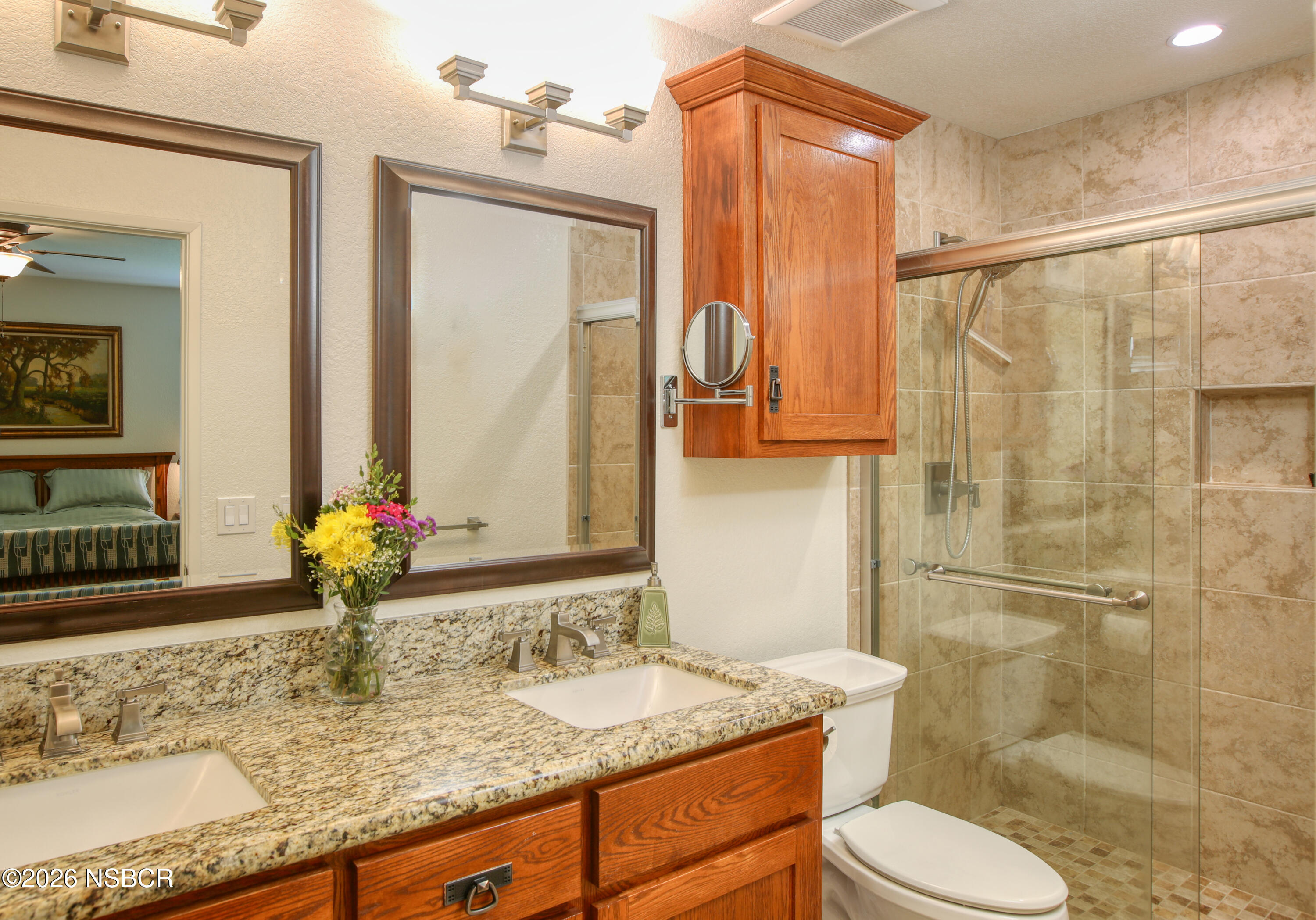 435-433 Eucalyptus Road, Unit 435433 Nipomo, CA 93444 - Photo 21 of 78 a bathroom with a granite countertop sink toilet and shower