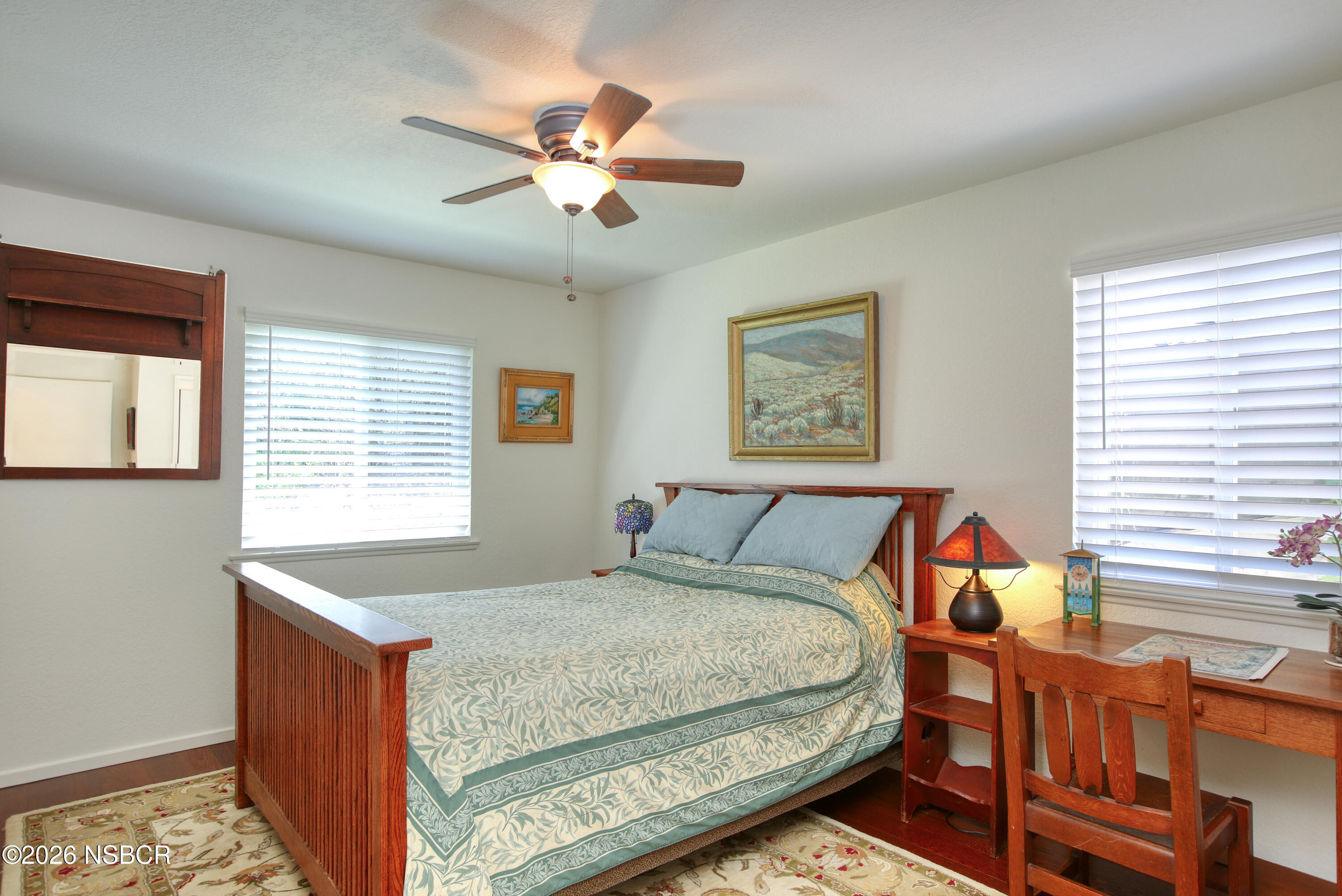 435-433 Eucalyptus Road, Unit 435433 Nipomo, CA 93444 - Photo 24 of 78 a bedroom with a bed and a chandelier