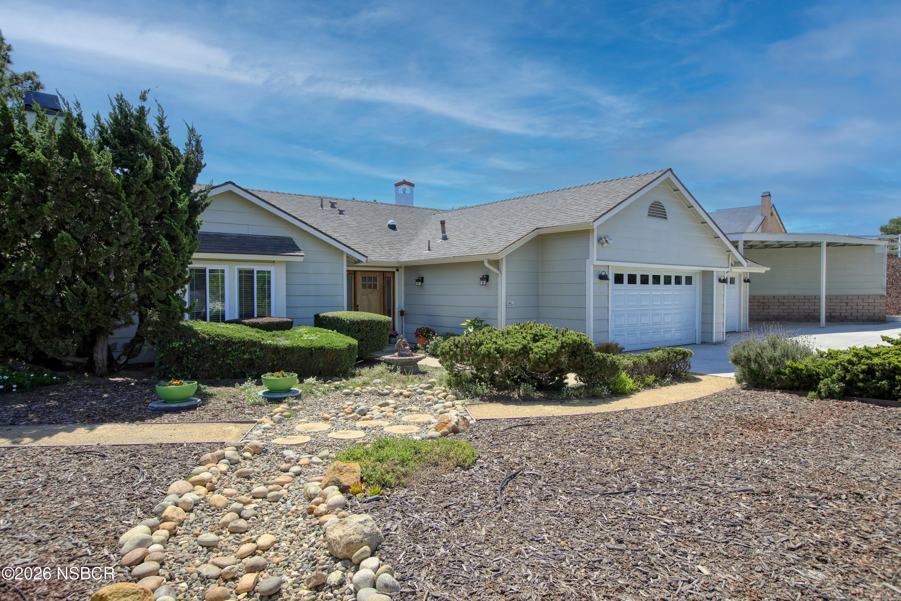 435-433 Eucalyptus Road, Unit 435433 Nipomo, CA 93444 - Photo 25 of 78 a front view of a house with a yard