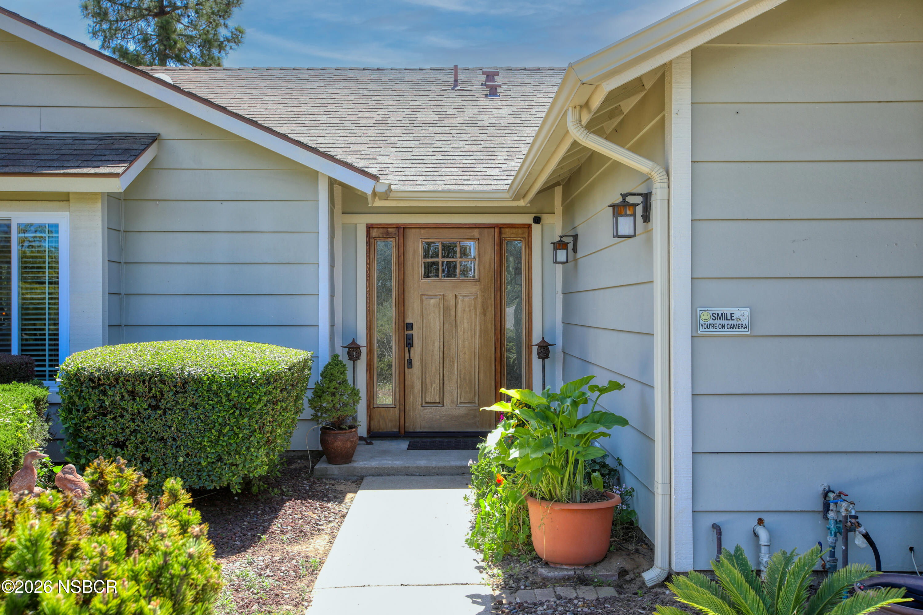 435-433 Eucalyptus Road, Unit 435433 Nipomo, CA 93444 - Photo 30 of 78 a house with a potted plant in front of door