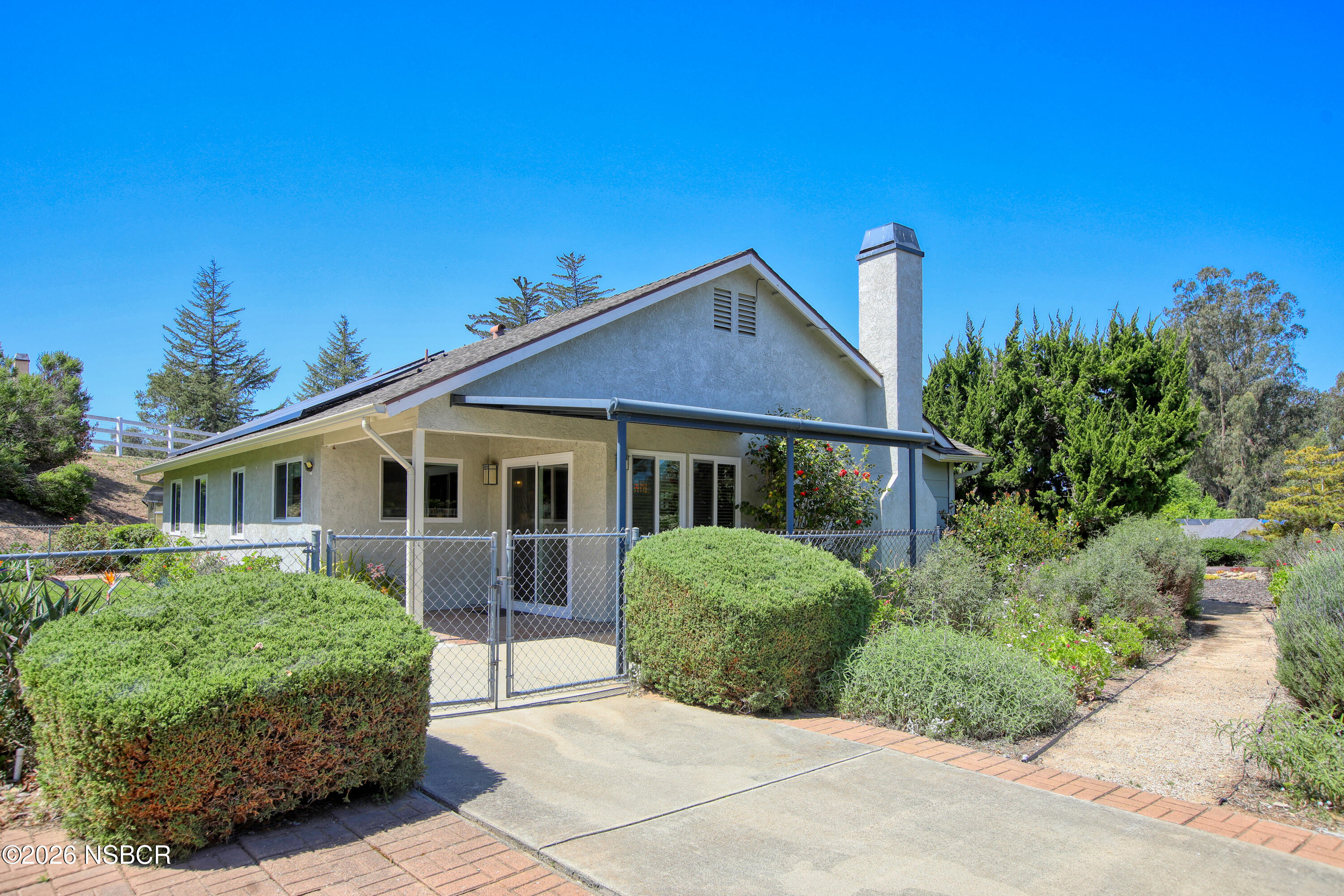 435-433 Eucalyptus Road, Unit 435433 Nipomo, CA 93444 - Photo 40 of 78 a front view of a house with a garden