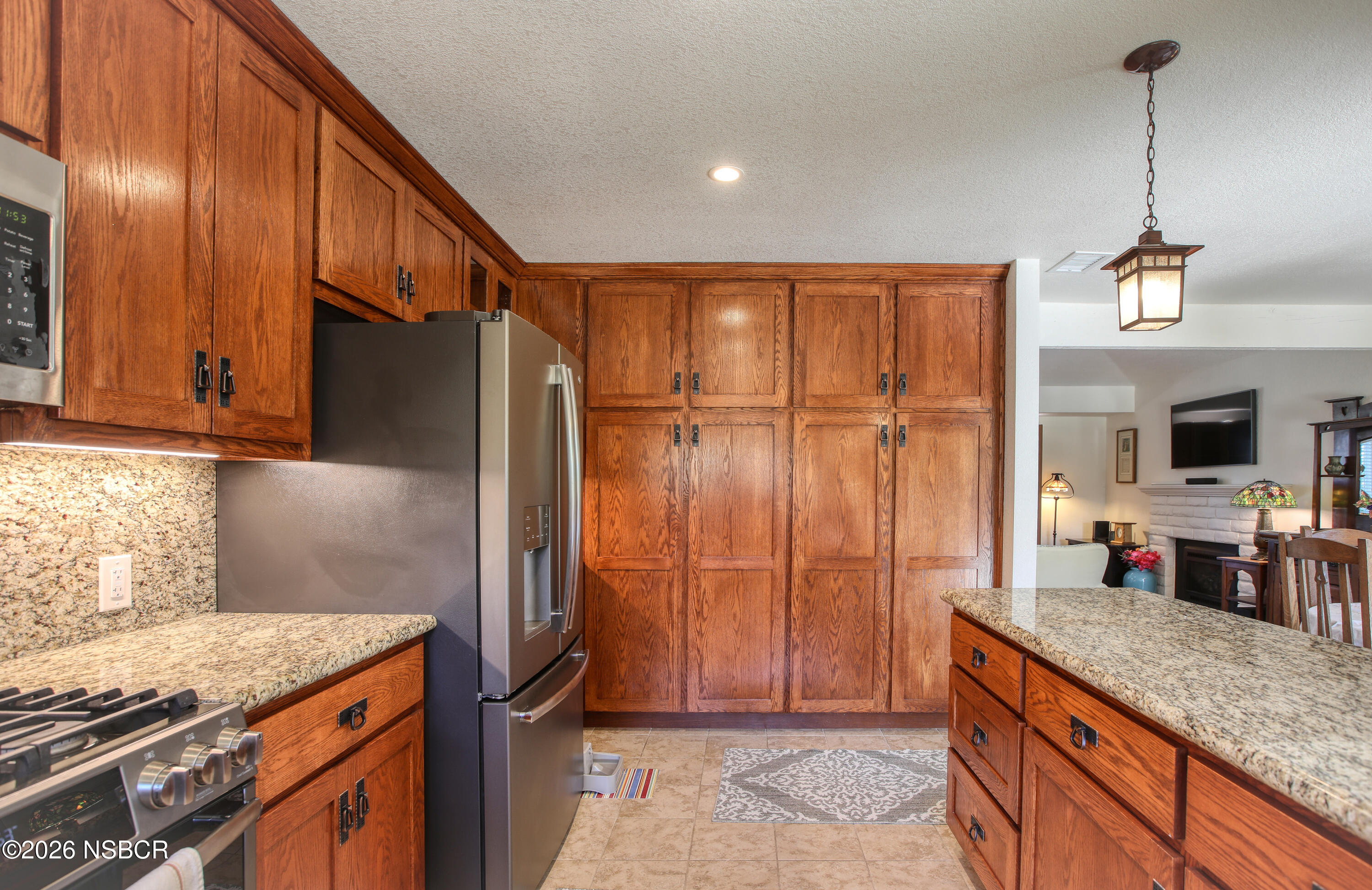 435-433 Eucalyptus Road, Unit 435433 Nipomo, CA 93444 - Photo 4 of 78 a kitchen with granite countertop a refrigerator and a sink