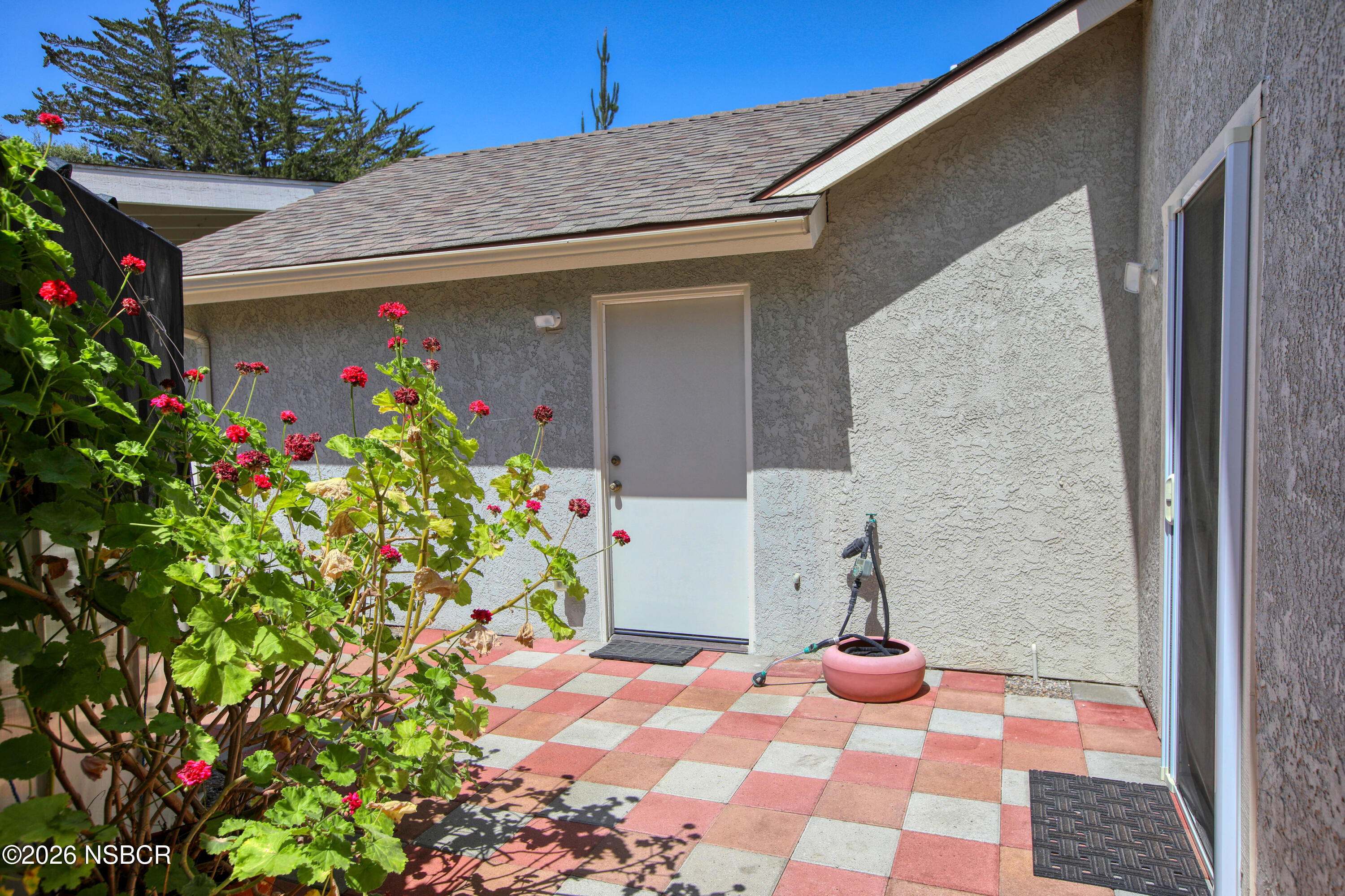435-433 Eucalyptus Road, Unit 435433 Nipomo, CA 93444 - Photo 46 of 78 a front view of a house with flowers