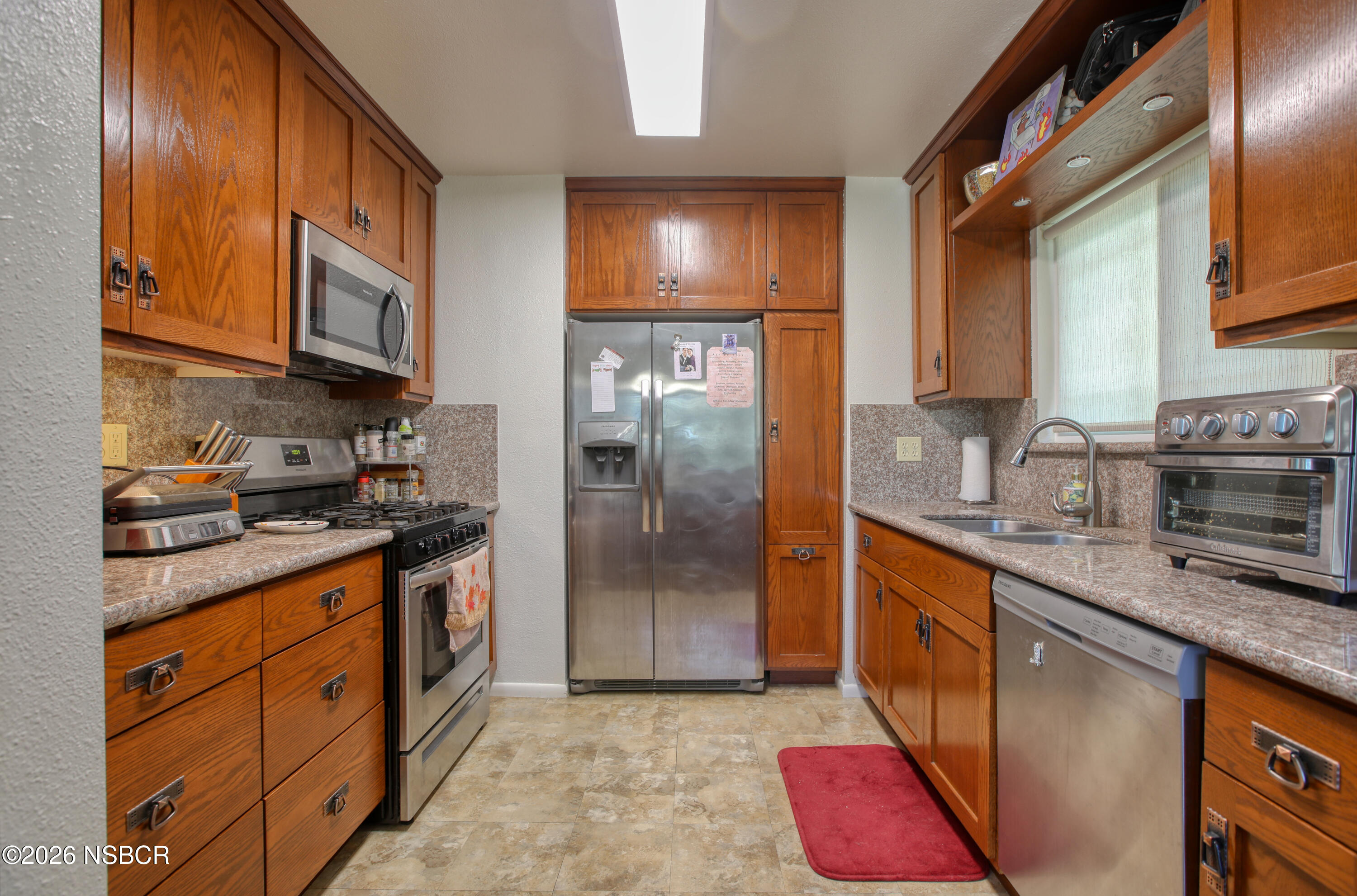 435-433 Eucalyptus Road, Unit 435433 Nipomo, CA 93444 - Photo 62 of 78 a kitchen with stainless steel appliances granite countertop a stove a sink dishwasher and a refrigerator